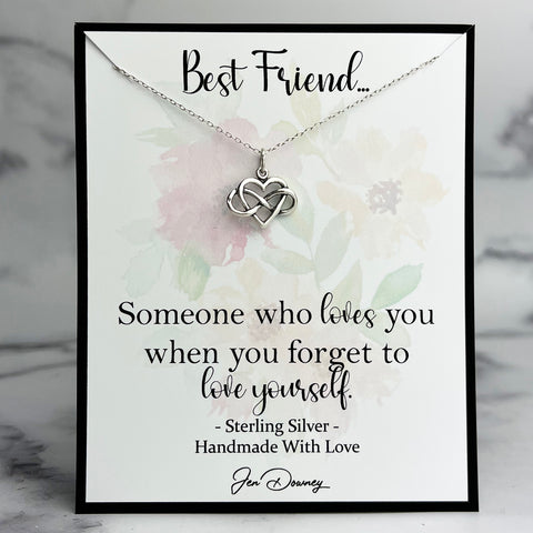 Necklace with heart and infinity symbol on a floral card with text